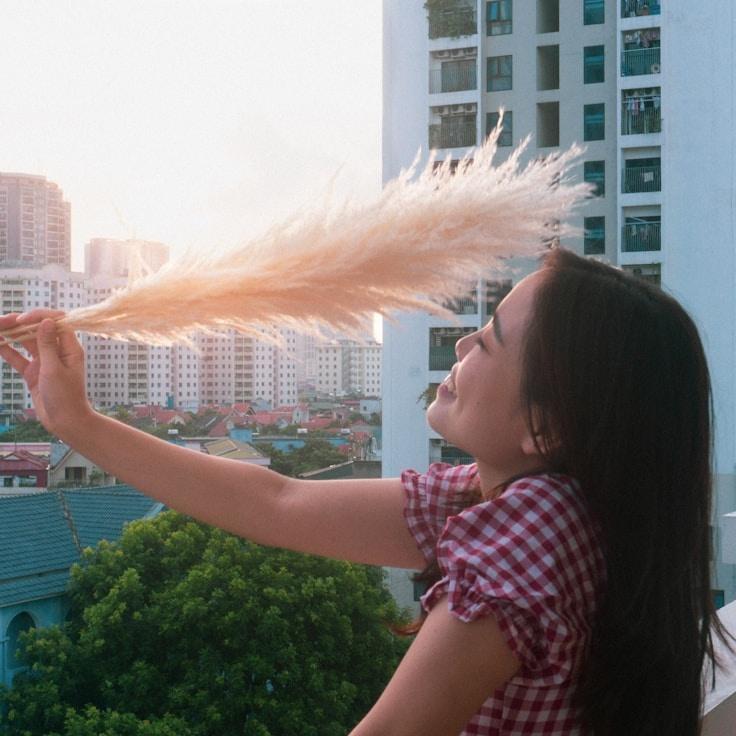 Alex Rivera, Lead Design Curator at River Plume Brook, reviewing corporate floral arrangements